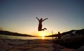 Silhouette of a girl jumping at sunset on the beach Royalty Free Stock Photo