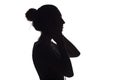 Silhouette of a girl listening to music in headphones on a white isolated background Royalty Free Stock Photo