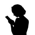 Silhouette of a girl looking into a mobile phone Royalty Free Stock Photo