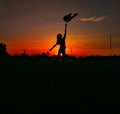 Silhouette of a girl. Orange sunset. Magical object in the sky Royalty Free Stock Photo