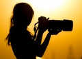 Silhouette of a girl photographer at sunset Royalty Free Stock Photo