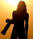 Silhouette of a girl photographer at sunset Royalty Free Stock Photo