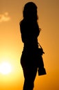 Silhouette of a girl photographer at sunset Royalty Free Stock Photo