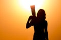 Silhouette of a girl photographer at sunset Royalty Free Stock Photo