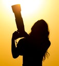 Silhouette of a girl photographer at sunset Royalty Free Stock Photo