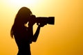 Silhouette of a girl photographer at sunset Royalty Free Stock Photo