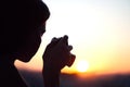 Silhouette of girl photographer taking picture setting sun on compact camera. sunset background Royalty Free Stock Photo