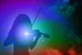 Silhouette of a girl playing the violin on a background of colorful outer space with musical notes and bright stars and nebulae
