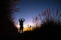 Silhouette of girl posing and stretching in vibrant natural background Royalty Free Stock Photo