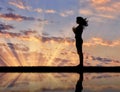 Silhouette of a girl practicing yoga
