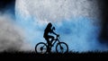 Silhouette of a girl riding a bicycle against the background of a blue moon. She drinks water from a bottle. Royalty Free Stock Photo