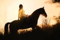 Silhouette of a girl riding a horse at the sunset Royalty Free Stock Photo