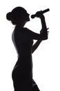 Silhouette of girl singing into microphone, profile of young woman face performing lyric song on white isolated background