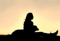 Silhouette of Girl Sitting OUtside with Large Dog Royalty Free Stock Photo