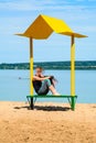 Empty beach with a bench with a canopy on the coast Royalty Free Stock Photo