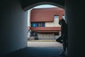 silhouette of a girl stands a tunnel from the arch of the house Royalty Free Stock Photo