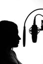 Silhouette of a girl with a studio microphone, Radio presenter, singer and blogger, voice acting for films. Strong, black and