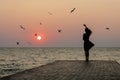 Silhouette of a girl on a sunset background sunrise on the sea