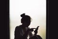 Silhouette of girl using smart phone Royalty Free Stock Photo