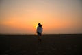 Silhouette girl walk into the sea.