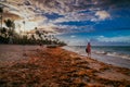 Silhouette of a girl walking along the beach at a beautiful sunset. Bavaro beach.