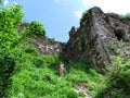 Silhouette of girl walking down the path among high stone walls of a medieval castle in Khust, Ukraine Royalty Free Stock Photo