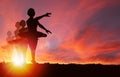 Silhouette Girls Dancing at Golden Sunrise