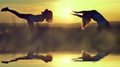 Silhouette girls stretching on a meadow