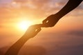 Silhouette of giving a helping hand, hope and support each other over sunset Royalty Free Stock Photo