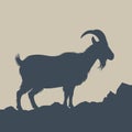 Silhouette of a goat standing on rocky terrain Royalty Free Stock Photo