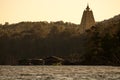 Silhouette golden chedi Buddhakhaya (mon) in the evening sunset sky with river and boat house at sangkhlaburi