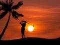 Silhouette golfer hitting golf shot on sunset Royalty Free Stock Photo