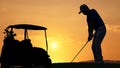 silhouette golfer playing golf with golf bag during beautiful sunset Royalty Free Stock Photo