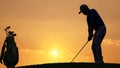 silhouette golfer playing golf with golf bag during beautiful sunset Royalty Free Stock Photo