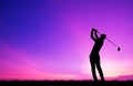 Silhouette golfer playing golf at beautiful sunset Royalty Free Stock Photo