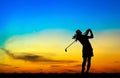 Silhouette golfer playing golf at beautiful sunset