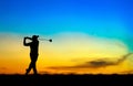 Silhouette golfer playing golf at beautiful sunset Royalty Free Stock Photo