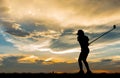 Silhouette golfer playing golf at beautiful sunset Royalty Free Stock Photo