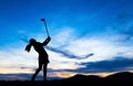 Silhouette golfer playing golf at beautiful sunset