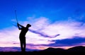 Silhouette golfer playing golf at beautiful sunset Royalty Free Stock Photo