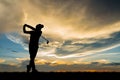 Silhouette golfer playing golf at beautiful sunset Royalty Free Stock Photo