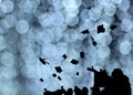 Silhouette of Graduate Students throw mortarboards in university graduation success ceremony. Congratulation on Education Succes Royalty Free Stock Photo