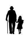 Silhouette of grandfather walking with granddaughter