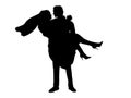 Silhouette of the groom holds the bride in his arms.