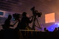 Silhouette of a group of cameramen broadcasting an event.