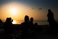Silhouette of group of friends hanging out on the beach. Royalty Free Stock Photo