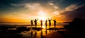 Silhouette of group of friends are having fun, having fun on the beach in the evening sunset Royalty Free Stock Photo