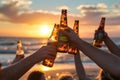 Silhouette of a group of friends having a party on a beach at sunset drinking beer Royalty Free Stock Photo