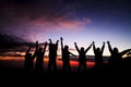 Silhouette of group of friends standing in sunset Royalty Free Stock Photo