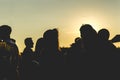 Silhouette of group of friends walking in the city during sunset against sky Royalty Free Stock Photo
